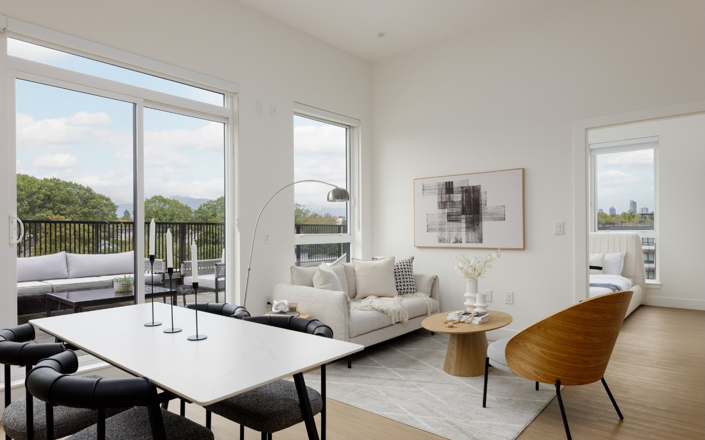 Bright living and dining space with balcony views